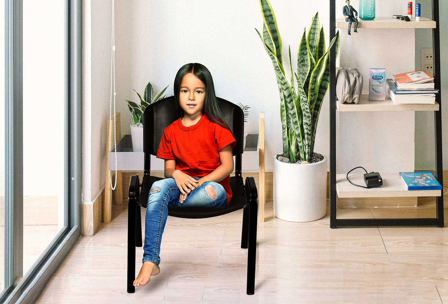 Child sitting on black Plastic Stacking Chair by Meta Furniture in bright modern room with plants