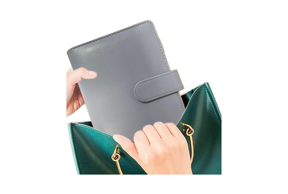 Gray Budget Binder with snap closure being placed into a green handbag by a person's hands