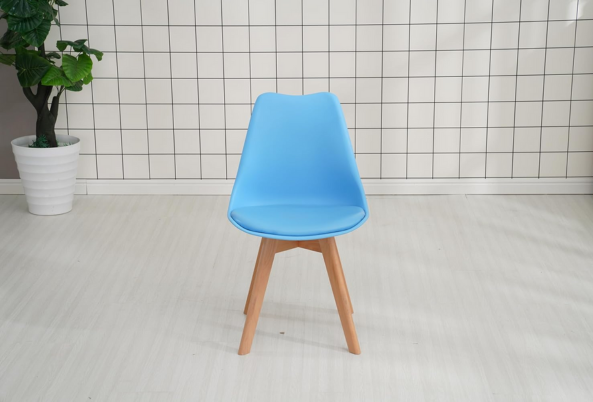 Meta Furniture blue dining chair with wooden legs set in modern white room with grid wall
